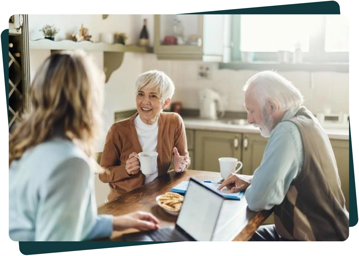 Agent meeting with an older couple at their kitchen table